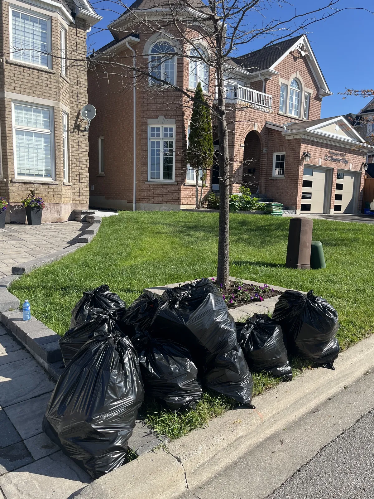 Piles of garbage bags and junk lined up before pickup