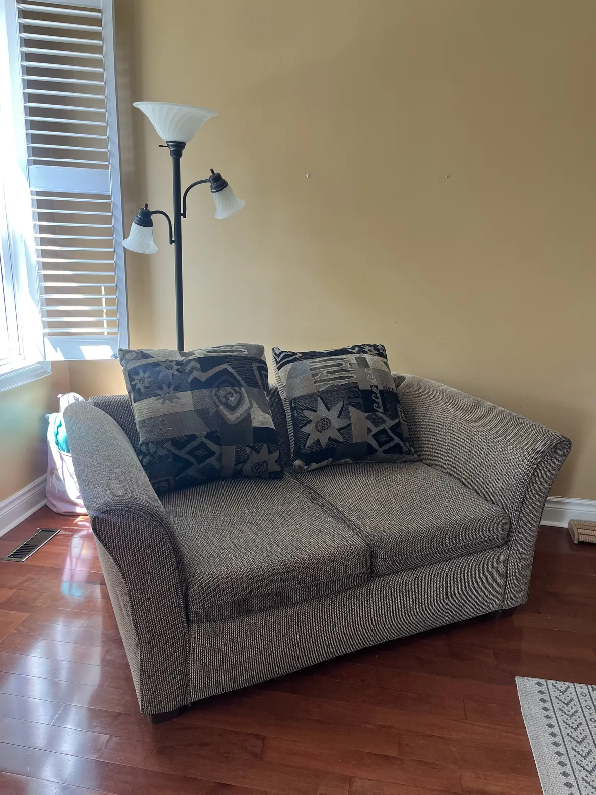 Old sofa and bulky items blocking a room before cleanup